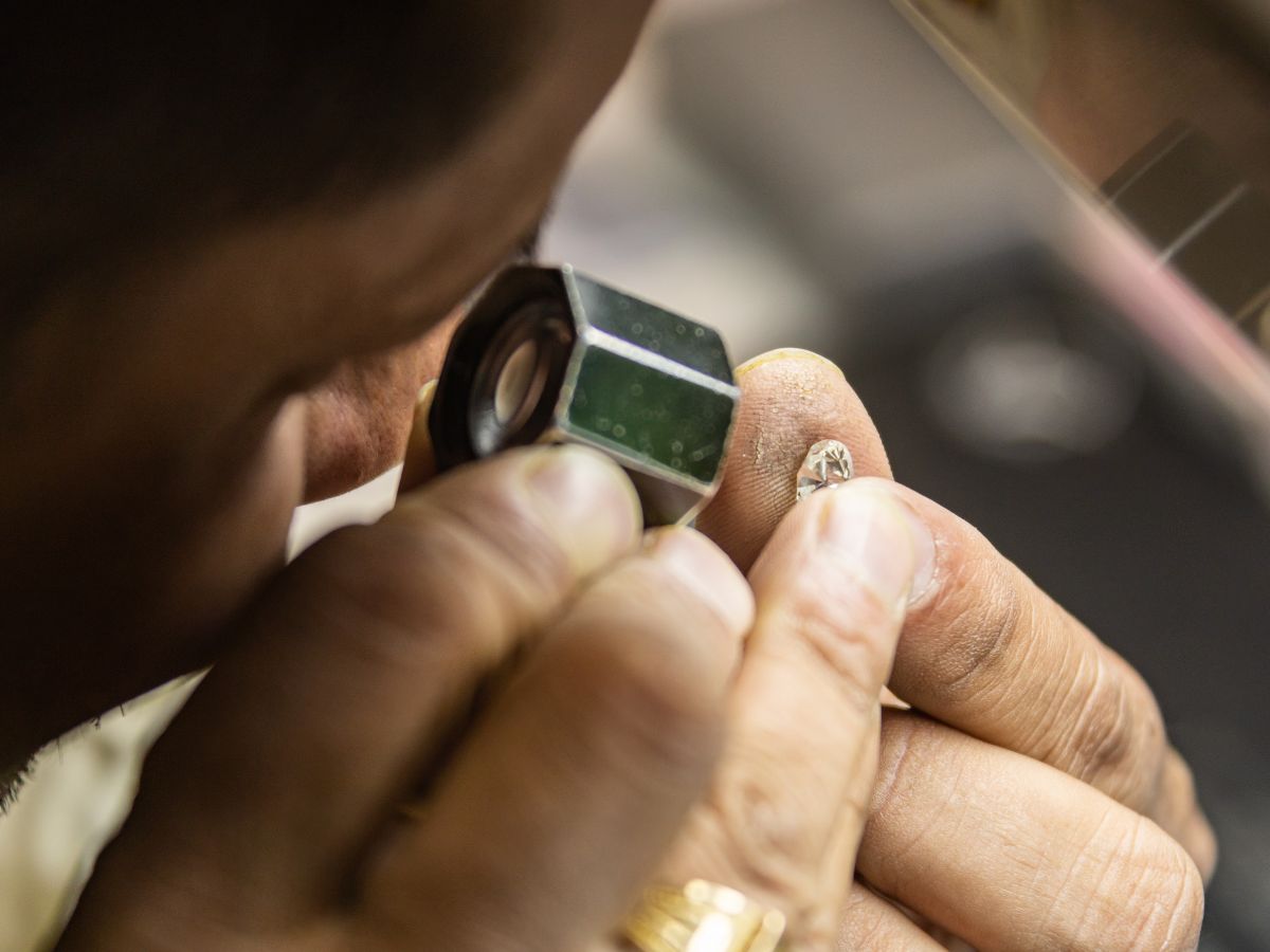 Jeweler inspecting cut diamond