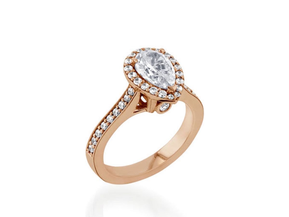 Rose gold engagement ring with pear-shaped diamond and halo setting