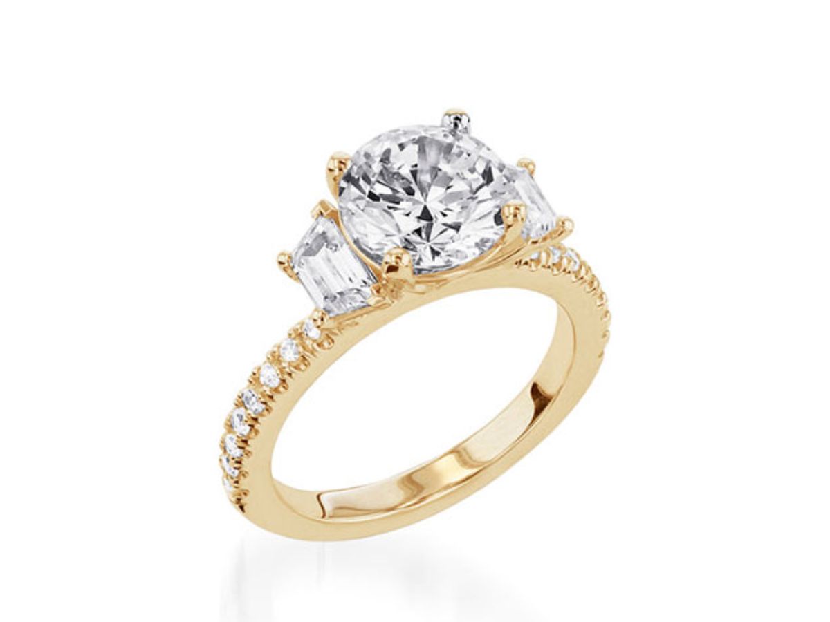 Three-stone diamond yellow gold ring with pavé-set accents