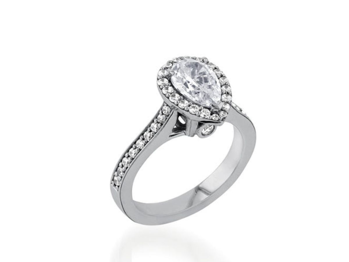 White gold engagement ring with pear-shaped diamond and halo setting