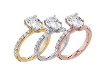 Three solitaire diamond engagement rings in yellow gold, white gold, and rose gold.