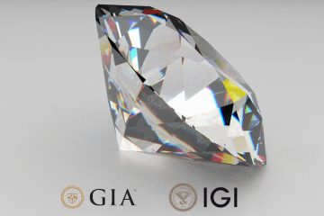 Brilliant-cut diamond near GIA and IGI logos on a gray surface.