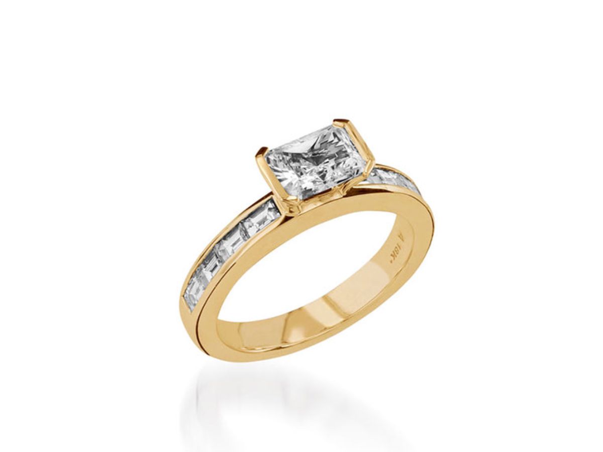 Gold ring featuring a radiant-cut diamond in East-West setting