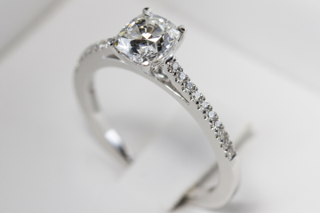Close-up of diamond engagement ring on white background