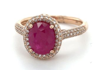 Rose gold ring with oval ruby gemstone and diamond halo set