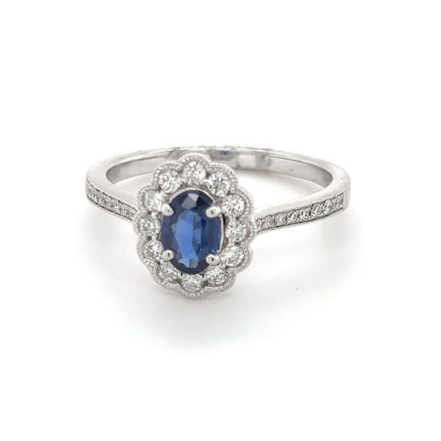 Oval sapphire ring with floral diamond halo setting