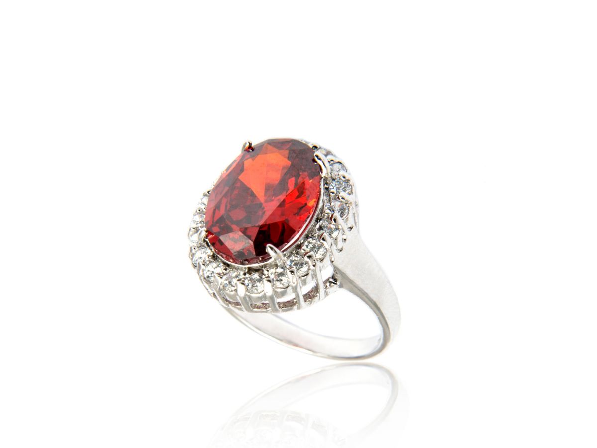 Silver ring with oval ruby gemstone and diamond halo set