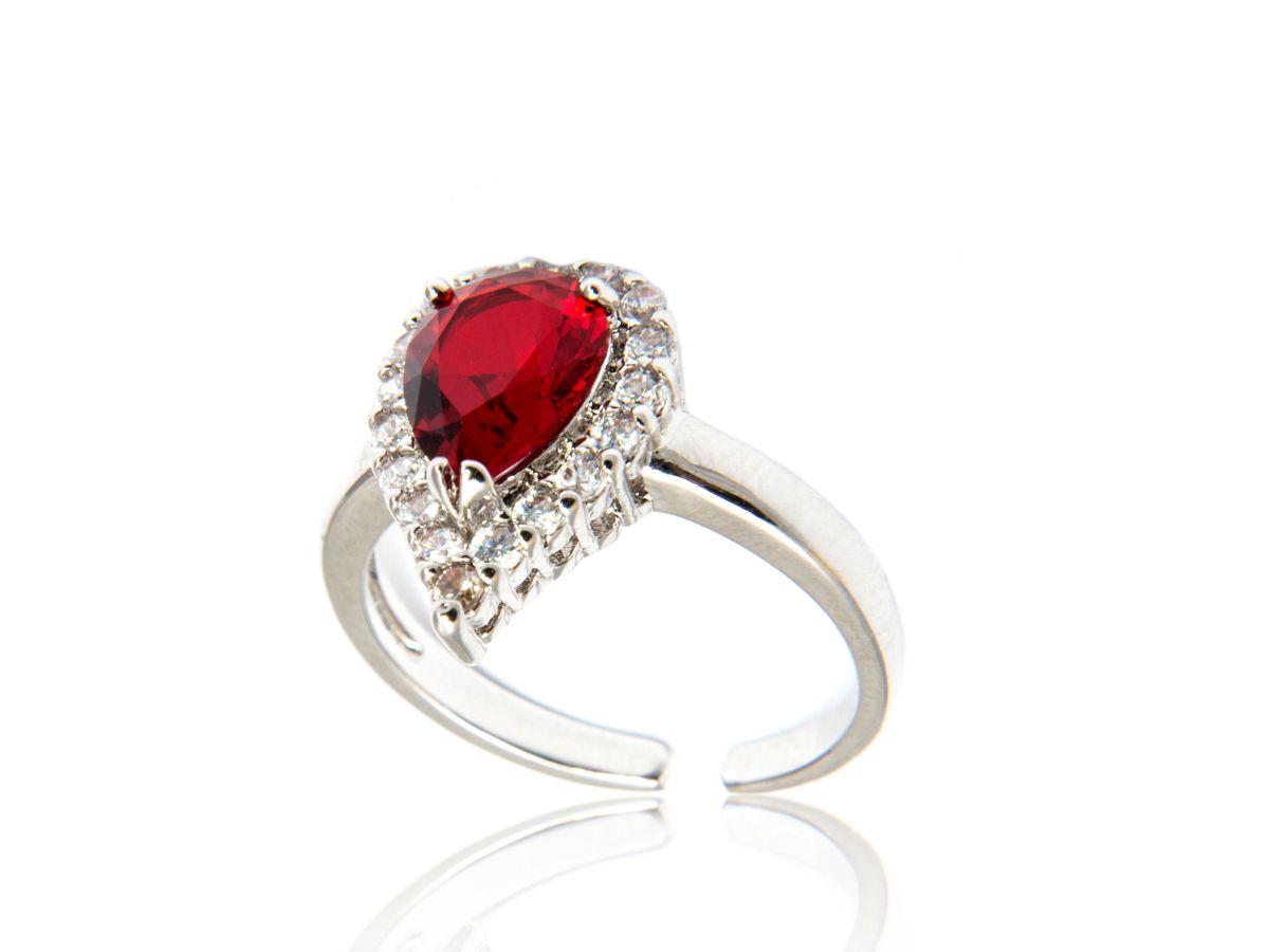Silver ring with pear ruby gemstone and diamond halo set