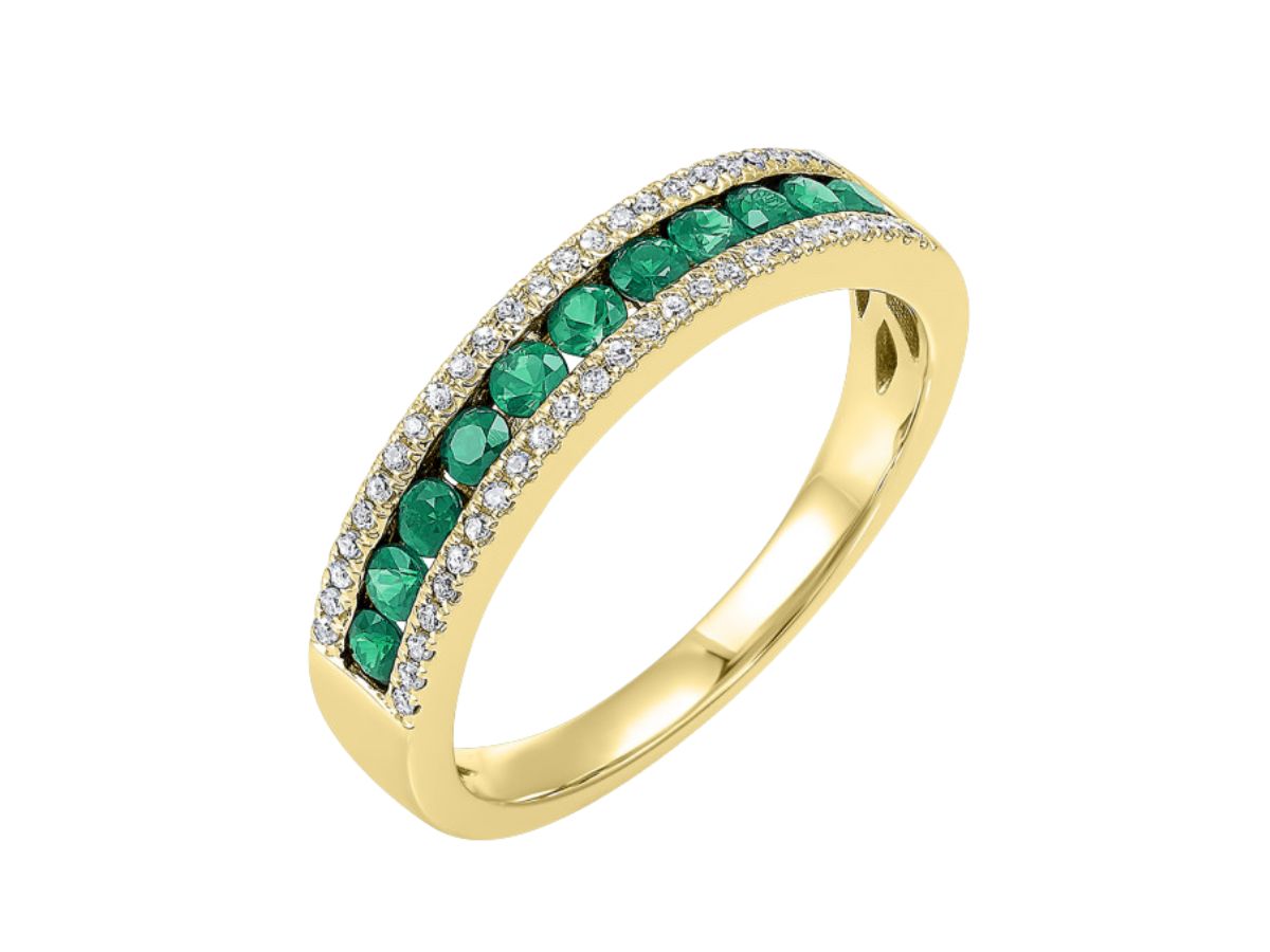 Yellow gold wedding band with emerald gemstone set in pavé diamond accents
