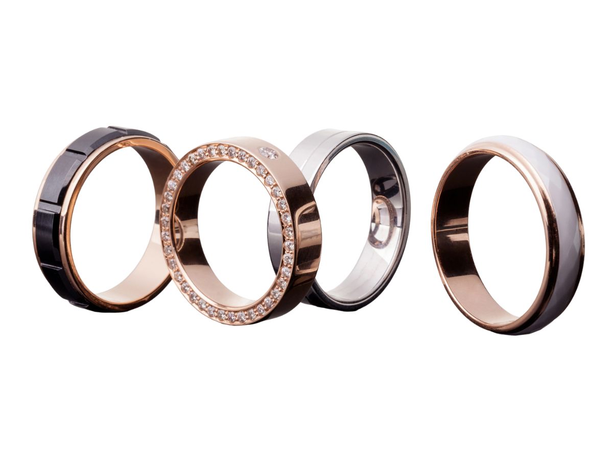 Set of stylish wedding bands in gold, black, and silver