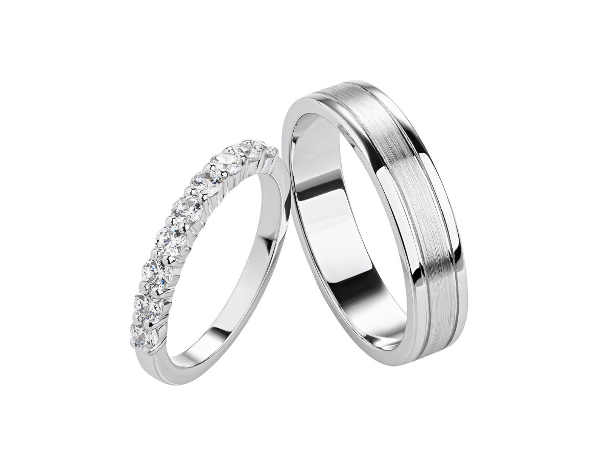 Silver wedding band and diamond ring on white background