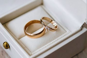 Close-up of elegant gold and diamond wedding bands in white box