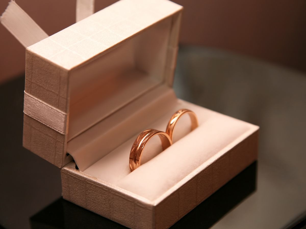 Gold wedding bands in elegant cream velvet ring box