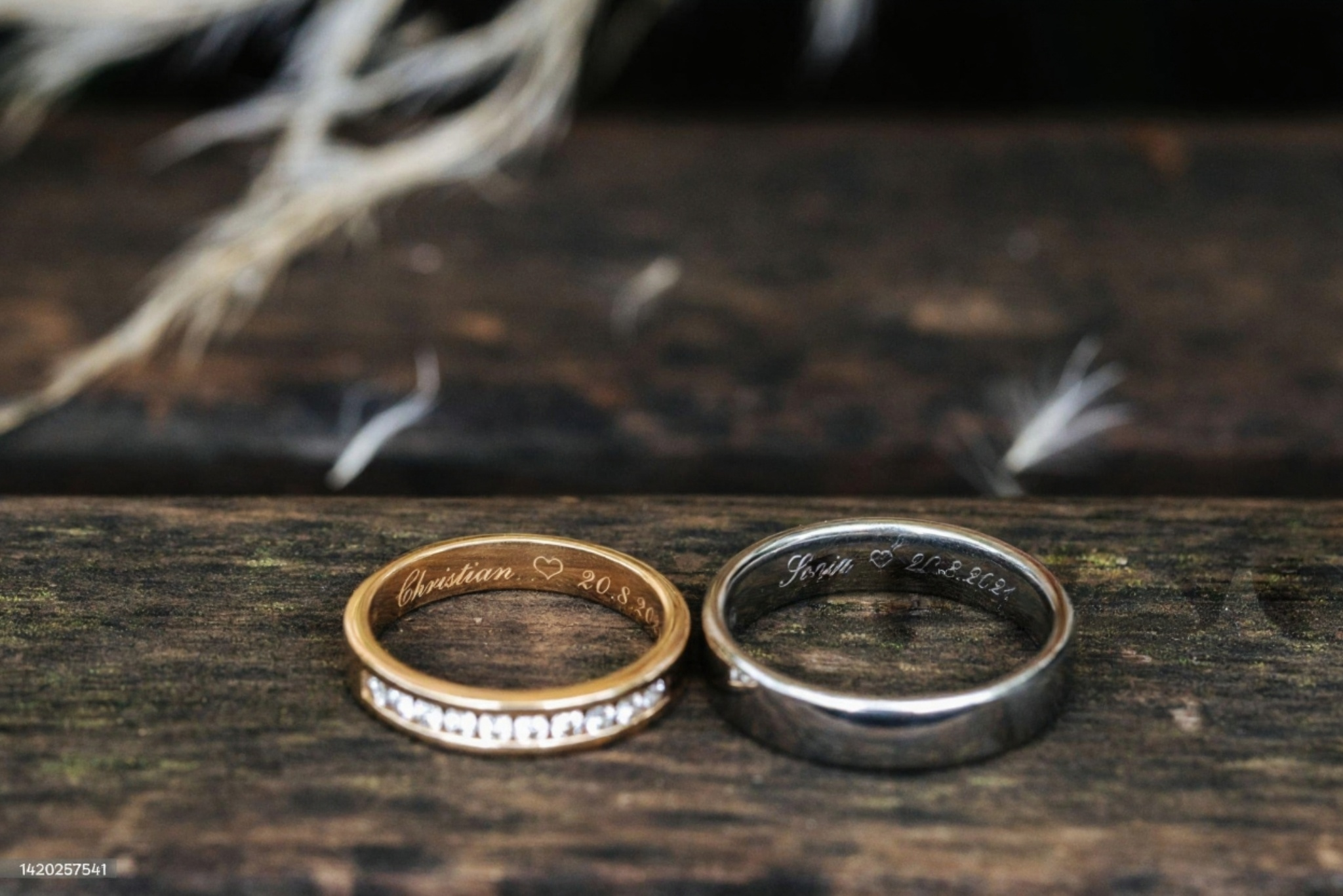 Gold and silver wedding bands engraved with couple names and wedding date
