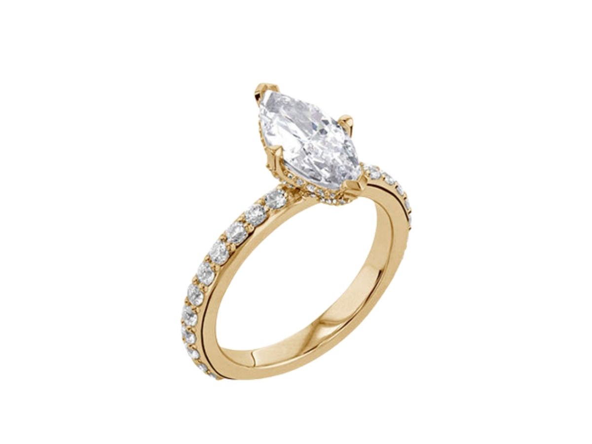 A yellow gold engagement ring with a marquise diamond set in a pavé band.