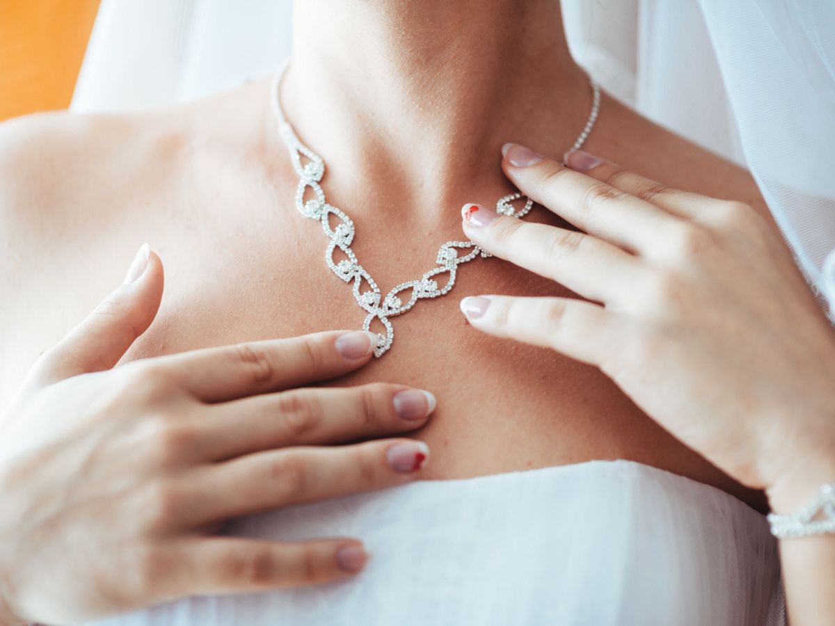 Bride wearing strapless gown and intricate diamond wedding necklace.
