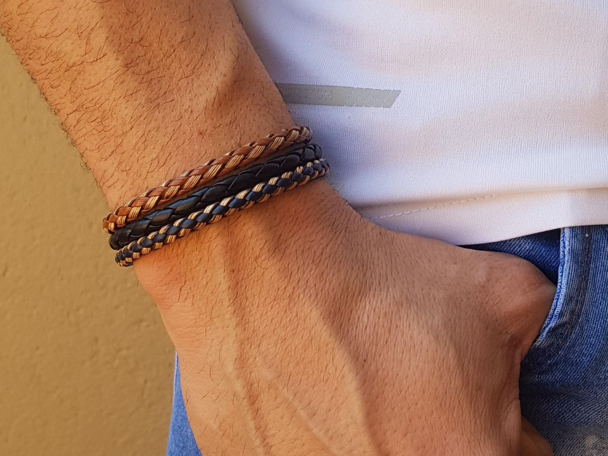 Casual braided leather bracelets in black and brown on man's wrist