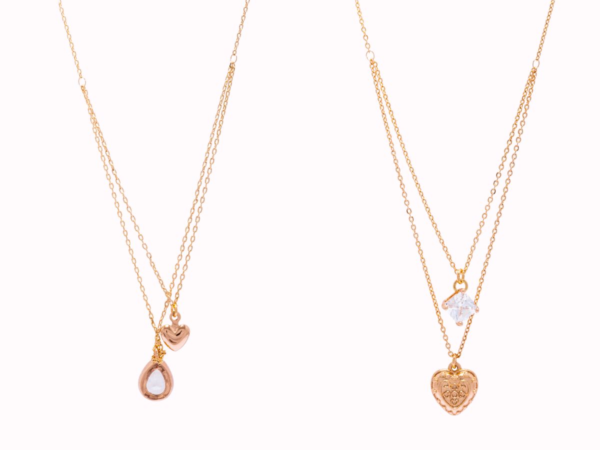 Layered gold necklaces with heart and stone charms