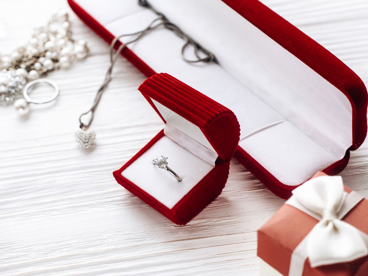 Elegant diamond ring in red velvet box with pearl necklace and gift box