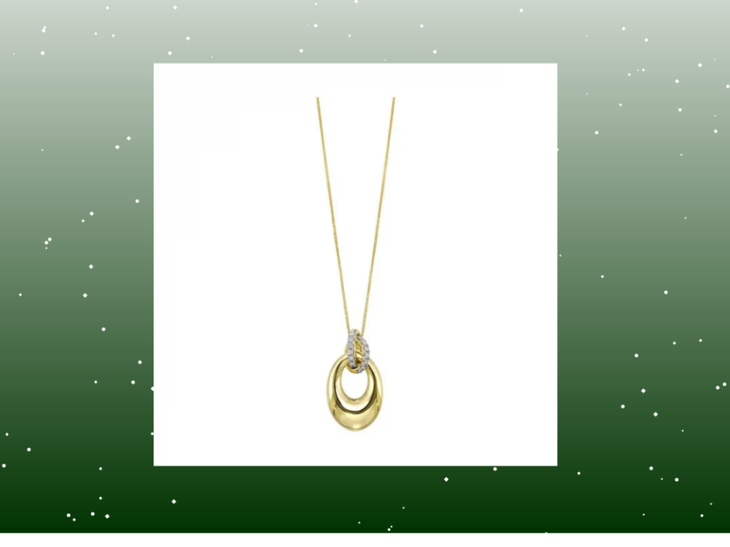 Holiday gold pendant necklace with diamonds on green snowy Christmas background