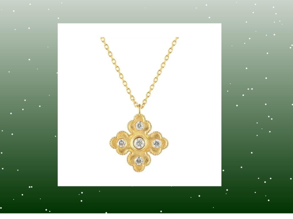 Gold floral diamond necklace with festive green Christmas snowy background