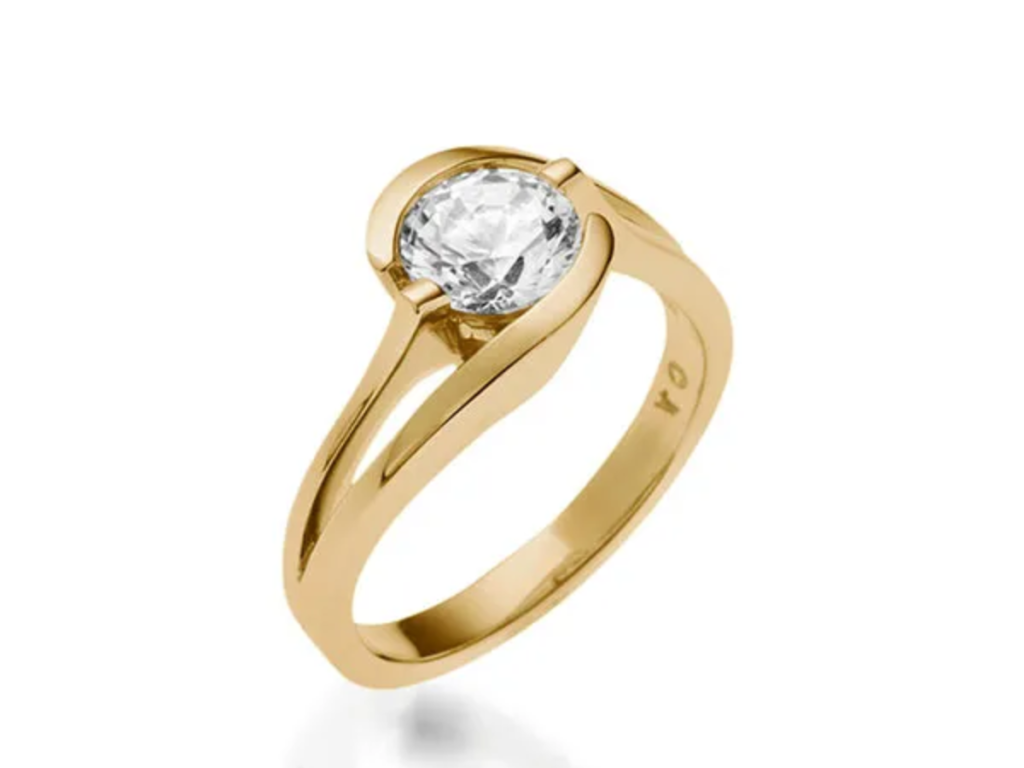 Yellow gold engagement ring with round diamond on split shank design.