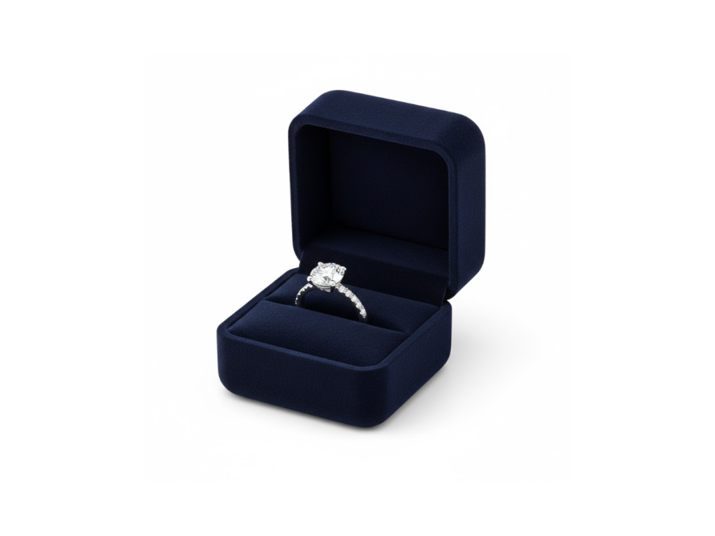 Diamond engagement ring displayed in a navy velvet ring box