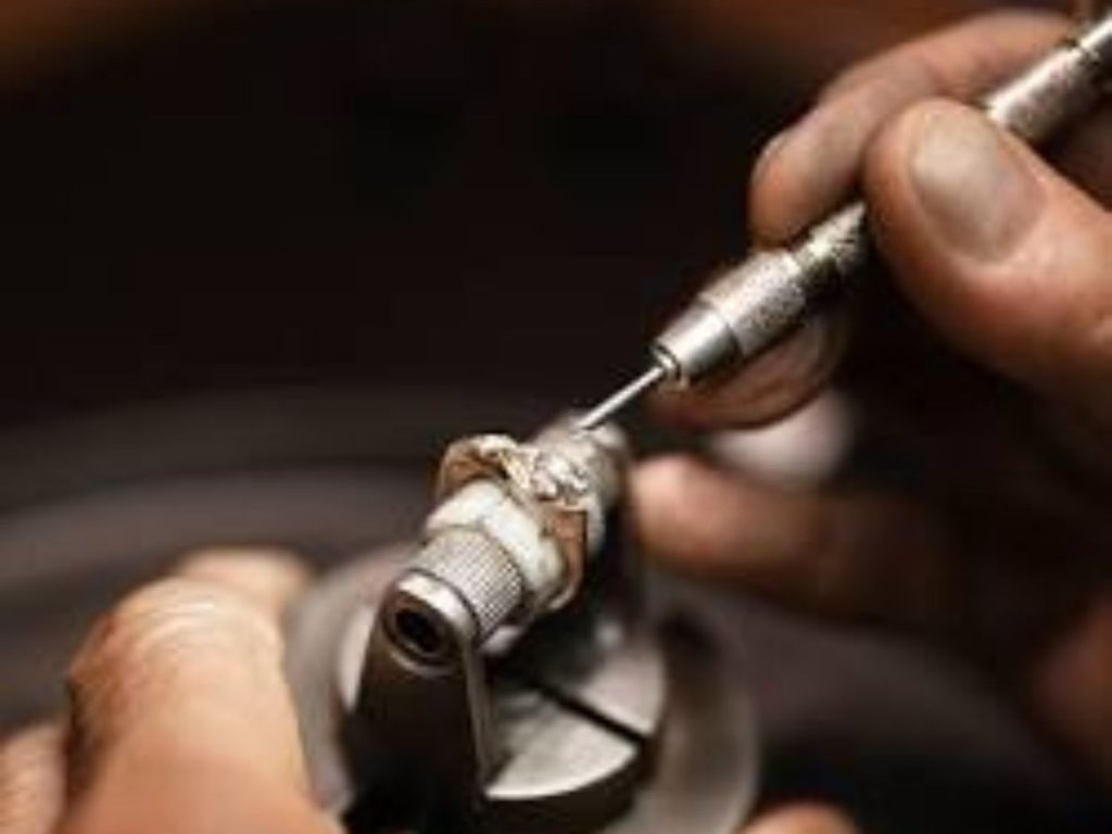 Jeweler polishing a diamond ring