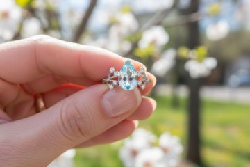 Pear cut gemstone ring held outdoors