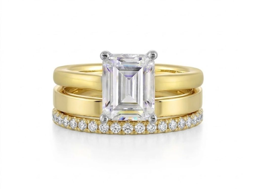 Emerald cut diamond engagement ring with stacked gold bands