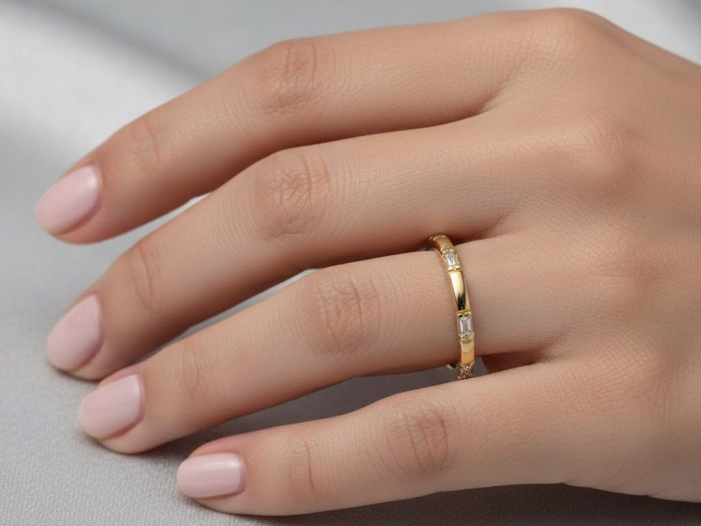 Hand wearing gold solitaire engagement ring