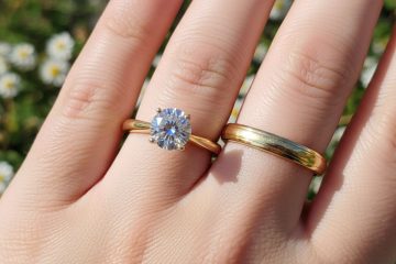 Gold engagement and wedding rings on hand
