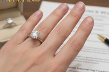 Diamond engagement ring on hand with insurance paperwork