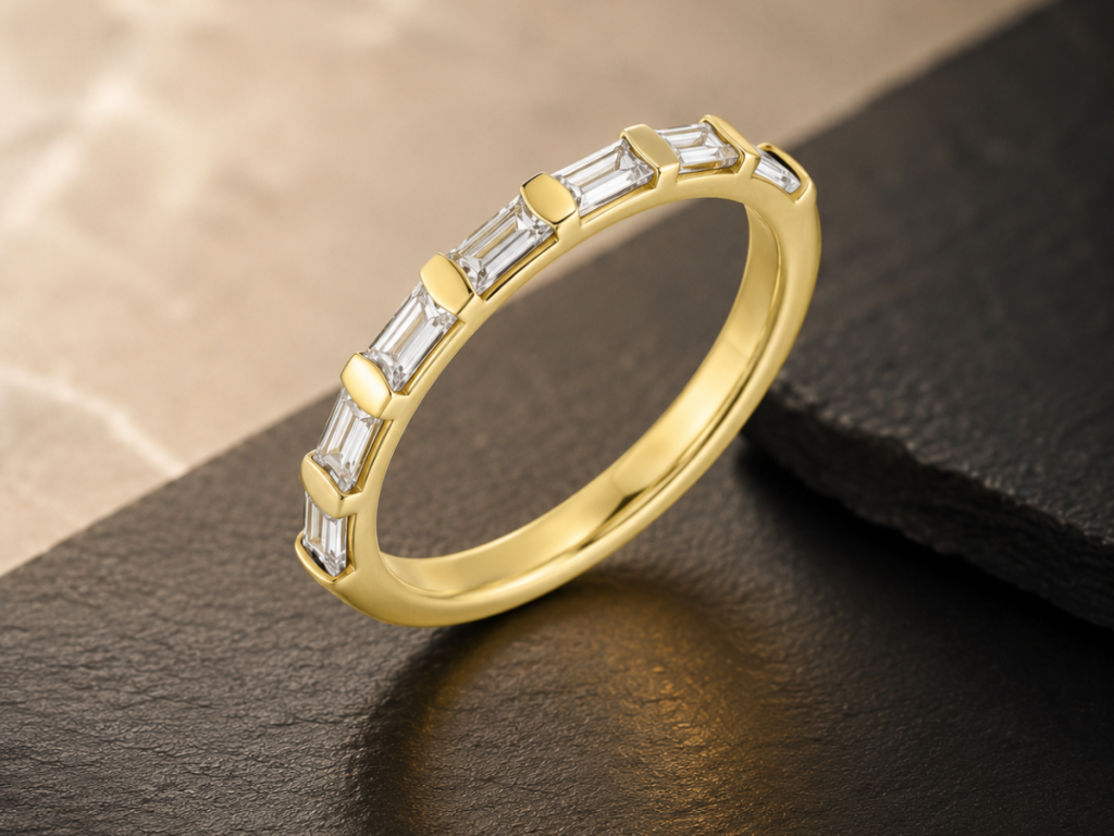 Gold baguette diamond wedding band on black stone