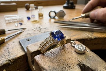 Blue sapphire engagement ring on jeweler workbench