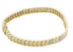 A yellow gold tennis bracelet with a textured, scalloped link design and small clear accent stones, photographed on a plain white background.