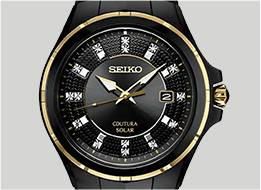 Seiko watch with black face and gold accents on a gray background